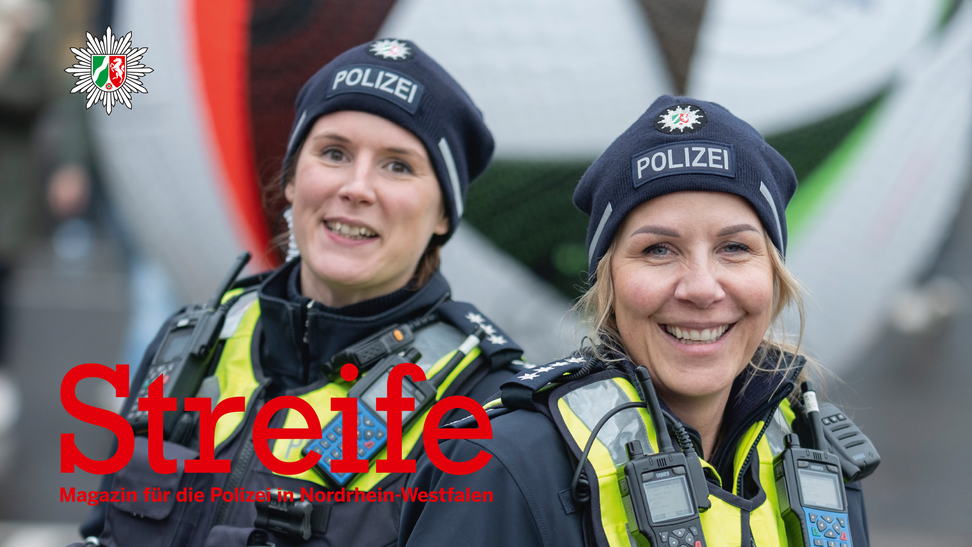 Police officers Nicole Kowalski and Jutta Rengelink from Dortmund police headquarters can be seen in the foreground. They are wearing uniforms and smiling at the camera. The official UEFA EURO 2024 soccer can be seen in large in the background. At the bottom left is the lettering "Streife", below it "Magazin für die Polizei in Nordrhein-Westfalen". The NRW police logo can be seen in the top left-hand corner.